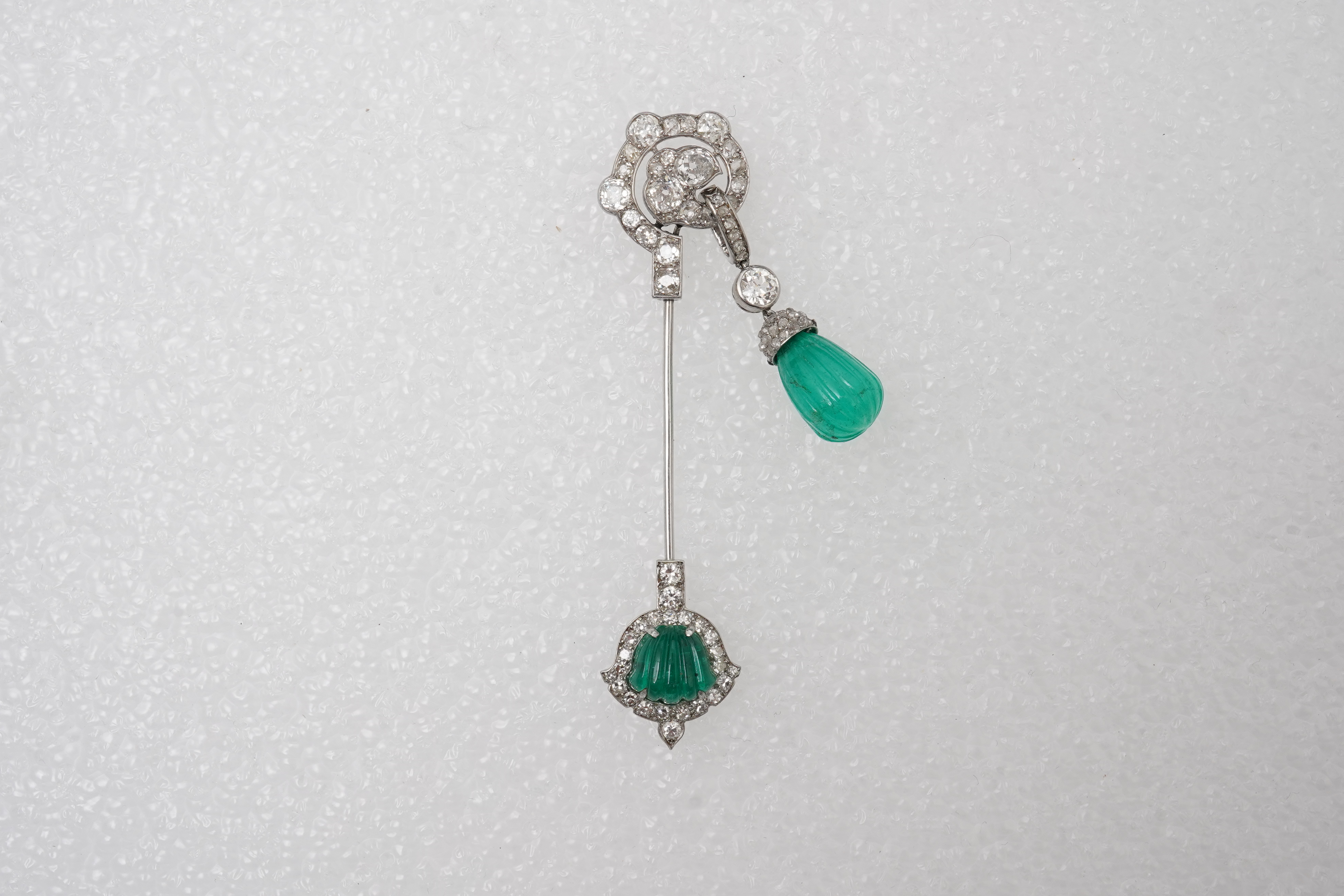 A fine Art Deco carved emerald and diamond jabot pin, circa 1925